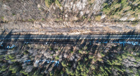 Aerial drone view of an railroad across the spring forest. Rural placesの写真素材