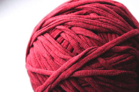 Close up view of red clew thread for knitting on white backgroundの写真素材