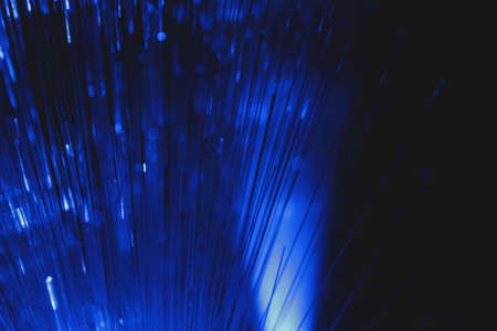 Abstract view of multicolor optical fibers on dark backgroundの写真素材