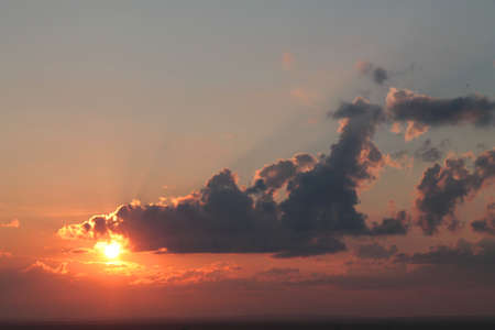 Beautiful view of a red sun set with clouds in summer