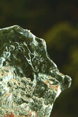 Close view of melting clear ice during spring with reflections
