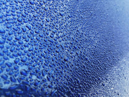 Rain drops at blue car body surface. Dark Blue car body panel after rain with lots of rain drops.の写真素材