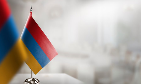 Small flags of the Armenia on an abstract blurry background.の写真素材