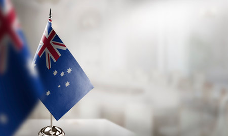 Small flags of the Australia on an abstract blurry background.の写真素材