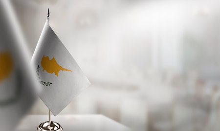 Small flags of the Cyprus on an abstract blurry background.の写真素材