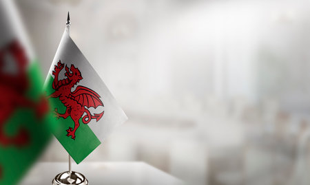 Small flags of the Wales on an abstract blurry background.の素材 [FY310197410270]