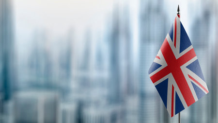 Small flags of the United Kingdom on an abstract blurry background.の写真素材