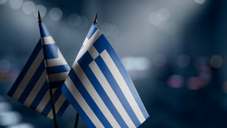 Small flags of the Greece on an abstract blurry background.の写真素材