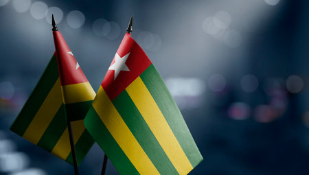 Small flags of the Togo on an abstract blurry background.の写真素材