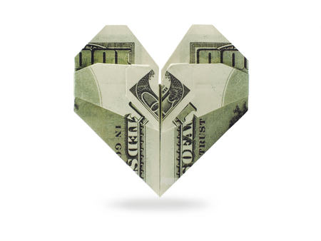 origami heart of dollars banknotes on a white backgroundの写真素材