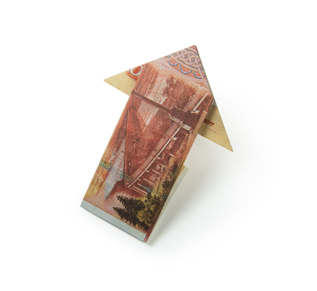 Arrow origami made of rubles bills on a white background