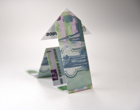 Arrow origami made of rubles bills on a white background