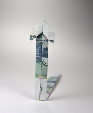 Arrow origami made of rubles bills on a white backgroundの写真素材