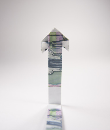 Arrow origami made of rubles bills on a white background