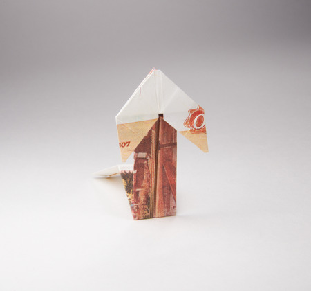 Arrow origami made of rubles bills on a white backgroundの写真素材