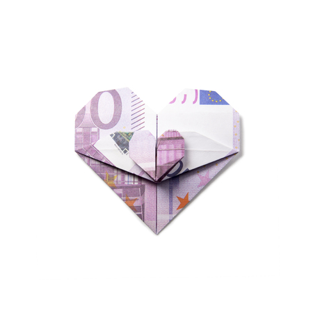 origami heart of banknotes on a white backgroundの写真素材