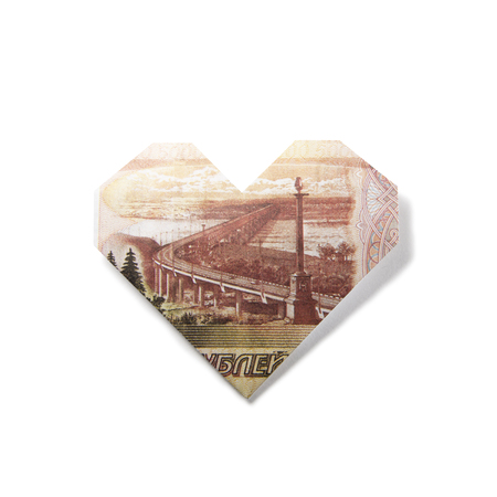 origami heart of banknotes on a white backgroundの写真素材