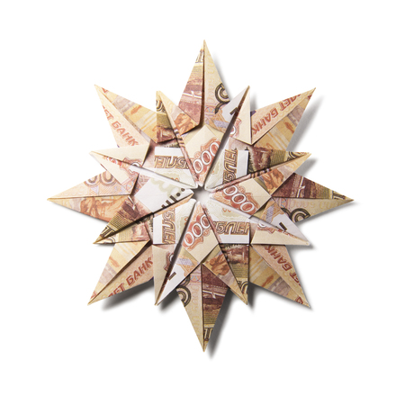 snowflake origami made of banknotes on a white background. Handmadeの写真素材
