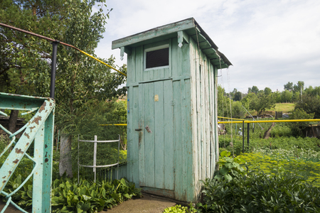 Rustic old wooden rural outside toilet outdoors on nature backgroundの写真素材