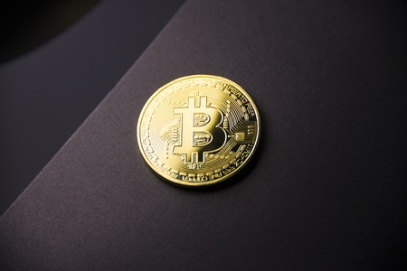 Gold coin Bitcoin on dark background. Cryptocurrency.