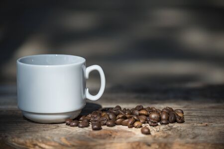 coffee Cup and coffee beans on wooden background.の写真素材