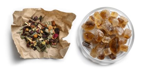 Green tea with natural aromatic additives and caramel sugar. Top view on white background