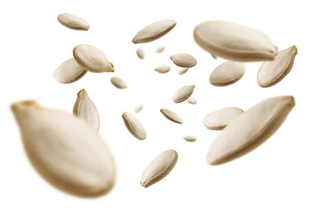 Pumpkin seeds levitate on a white background