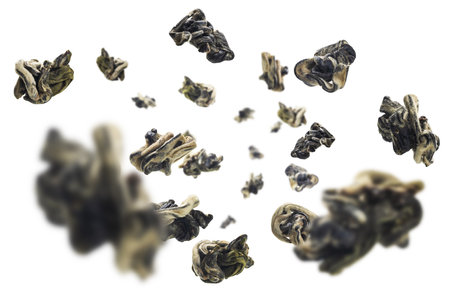 Dried Oolong tea levitates on a white background.
