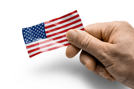 Hand holding a card with a national flag.の写真素材