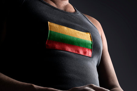The national flag of Lithuania on the athletes chestの写真素材