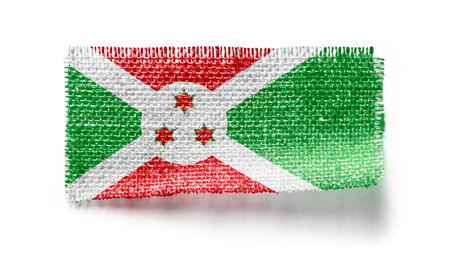 Burundi flag on a piece of cloth on a white backgroundの写真素材