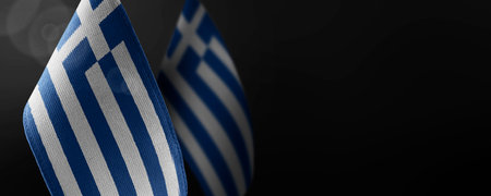 Small national flags of the Greece on a dark backgroundの写真素材