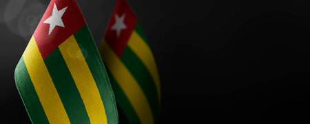 Small national flags of the Togo on a dark backgroundの写真素材