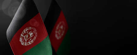Small national flags of the Afghanistan on a dark backgroundの写真素材