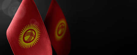 Small national flags of the Kirghizia on a dark background