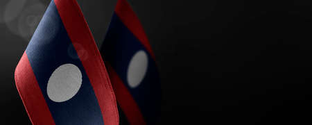 Small national flags of the Laos on a dark backgroundの写真素材