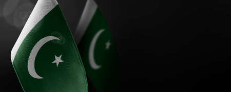 Small national flags of the Pakistan on a dark backgroundの写真素材