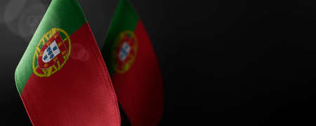 Small national flags of the Portugal on a dark backgroundの写真素材