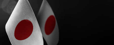 Small national flags of the Japan on a dark backgroundの写真素材