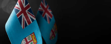Small national flags of the Fiji on a dark backgroundの写真素材