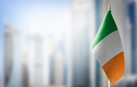 A small flag of Ireland on the background of a blurred backgroundの写真素材
