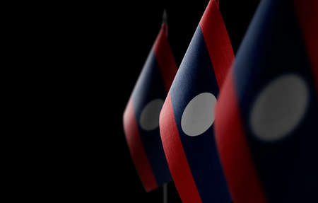 Small national flags of the Laos on a black backgroundの写真素材
