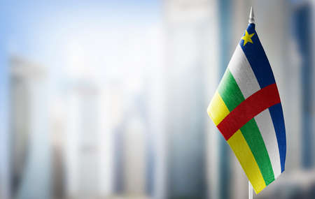 A small flag of Central African Republic on the background of a blurred backgroundの写真素材