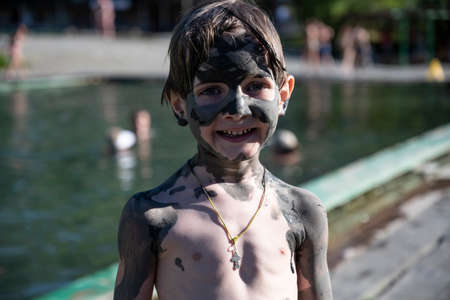 A boy in a source of hydrogen sulfide, a natural resort in the Republic of Abkhazia. A clear sunny day on May 19, 2021のeditorial素材