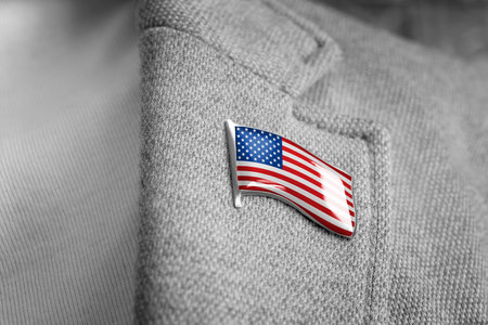 Metal badge with the flag of USA on a suit lapelの写真素材