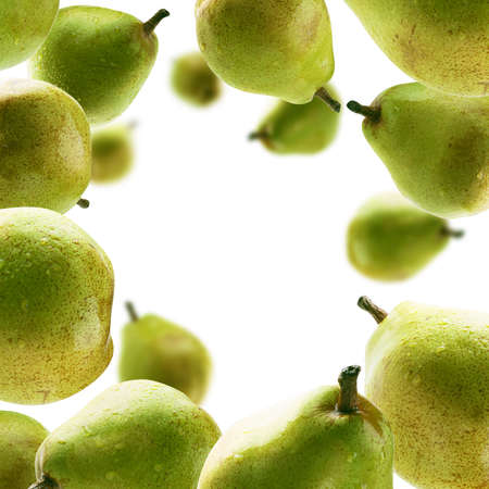 Green pears levitate on a white backgroundの写真素材