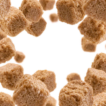 Brown cane sugar levitates on a white backgroundの写真素材