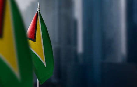 Small flags of Guyana on a blurry background of the cityの写真素材