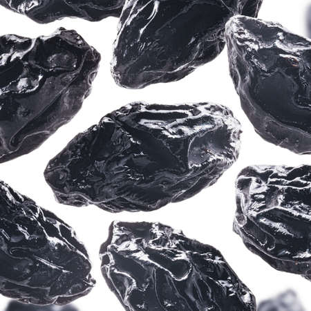 Dried prunes levitate on a white background.の写真素材