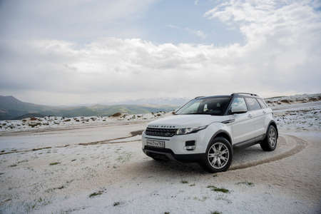 Range Rover Evoque car on the background of the mountains of the North Caucasus in Russia. Cloudy day on June 5, 2022のeditorial素材